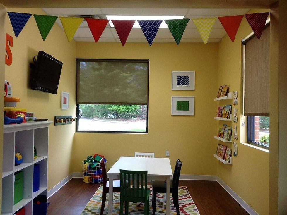 A child-friendly therapy room with toys, table seating, and books